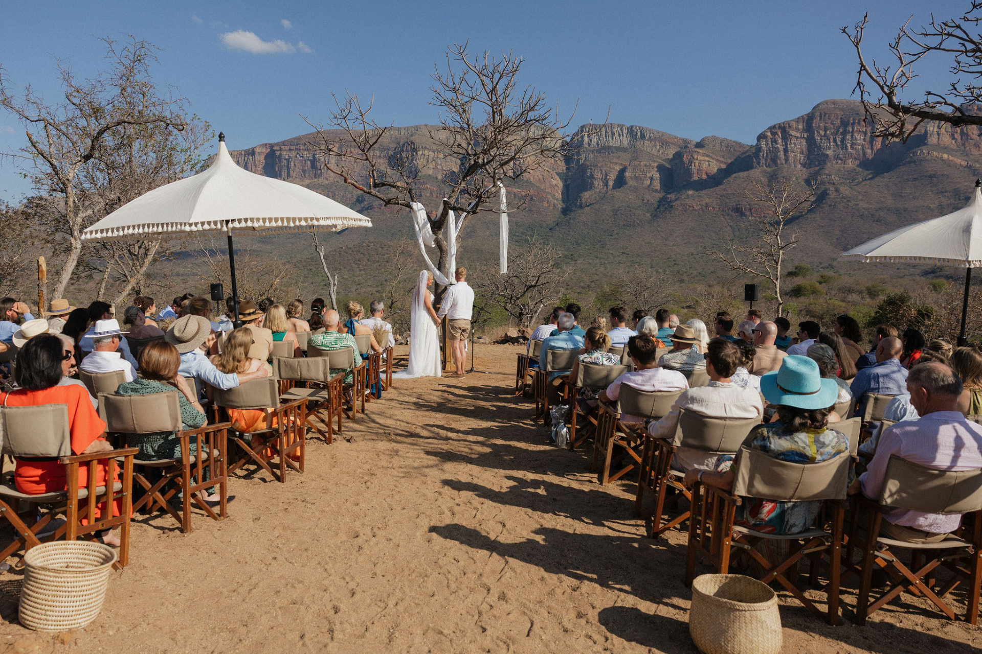 Outdoor wedding ceremony beneath the mountains at MyAfrica Farm