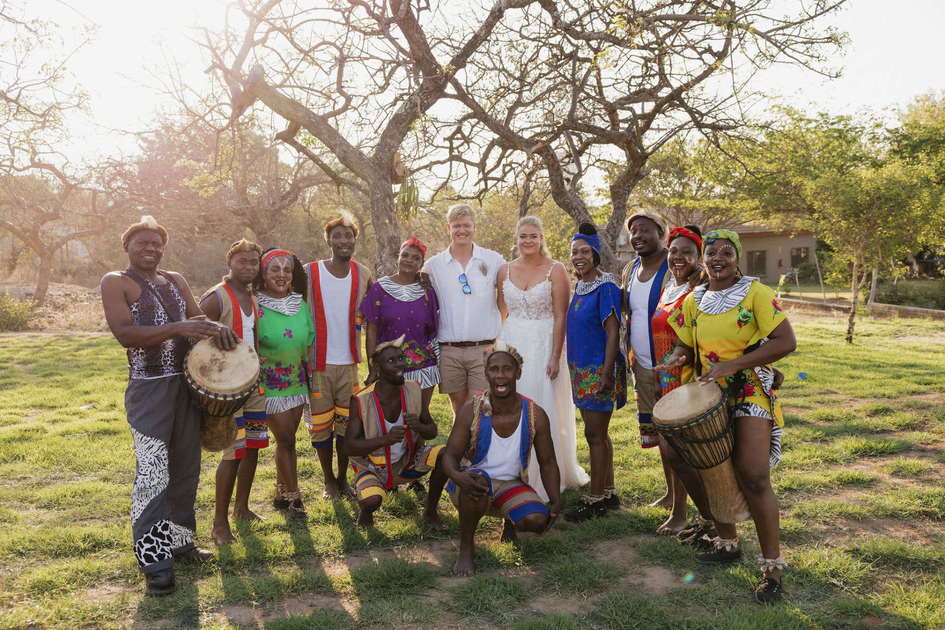The newlyweds posing with a traditional performance group