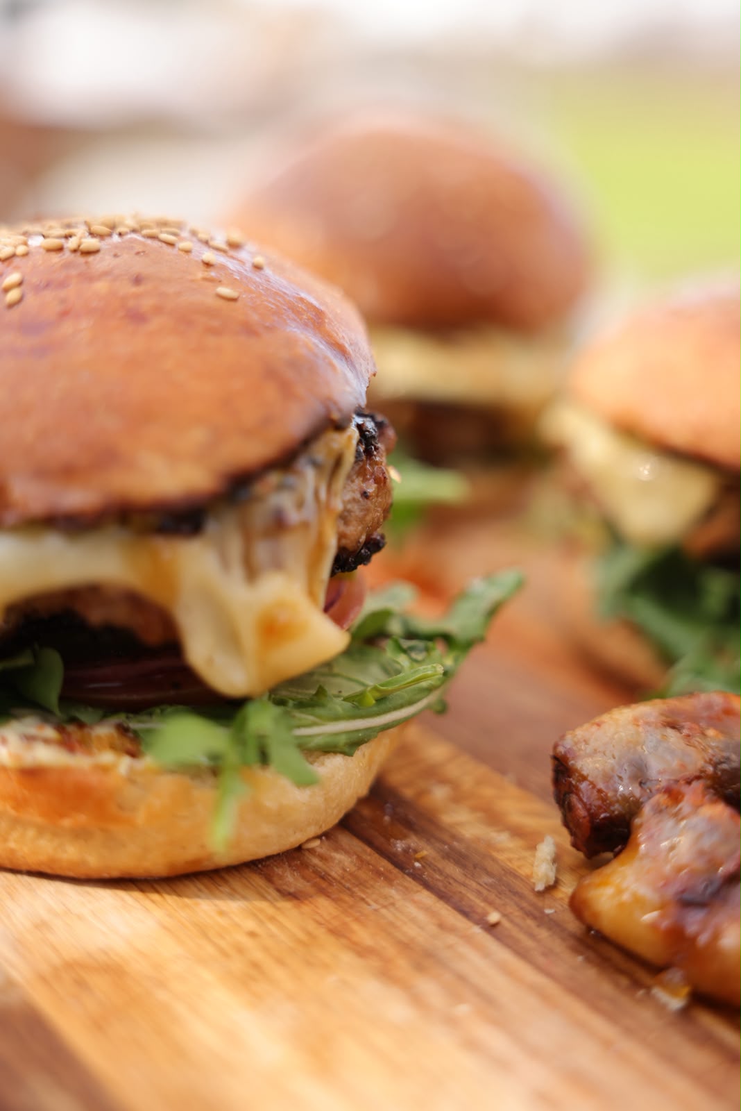 Cheeseburgers served on a wooden board