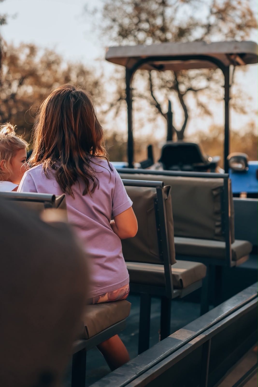 Two children riding on the tractor tour vehicle