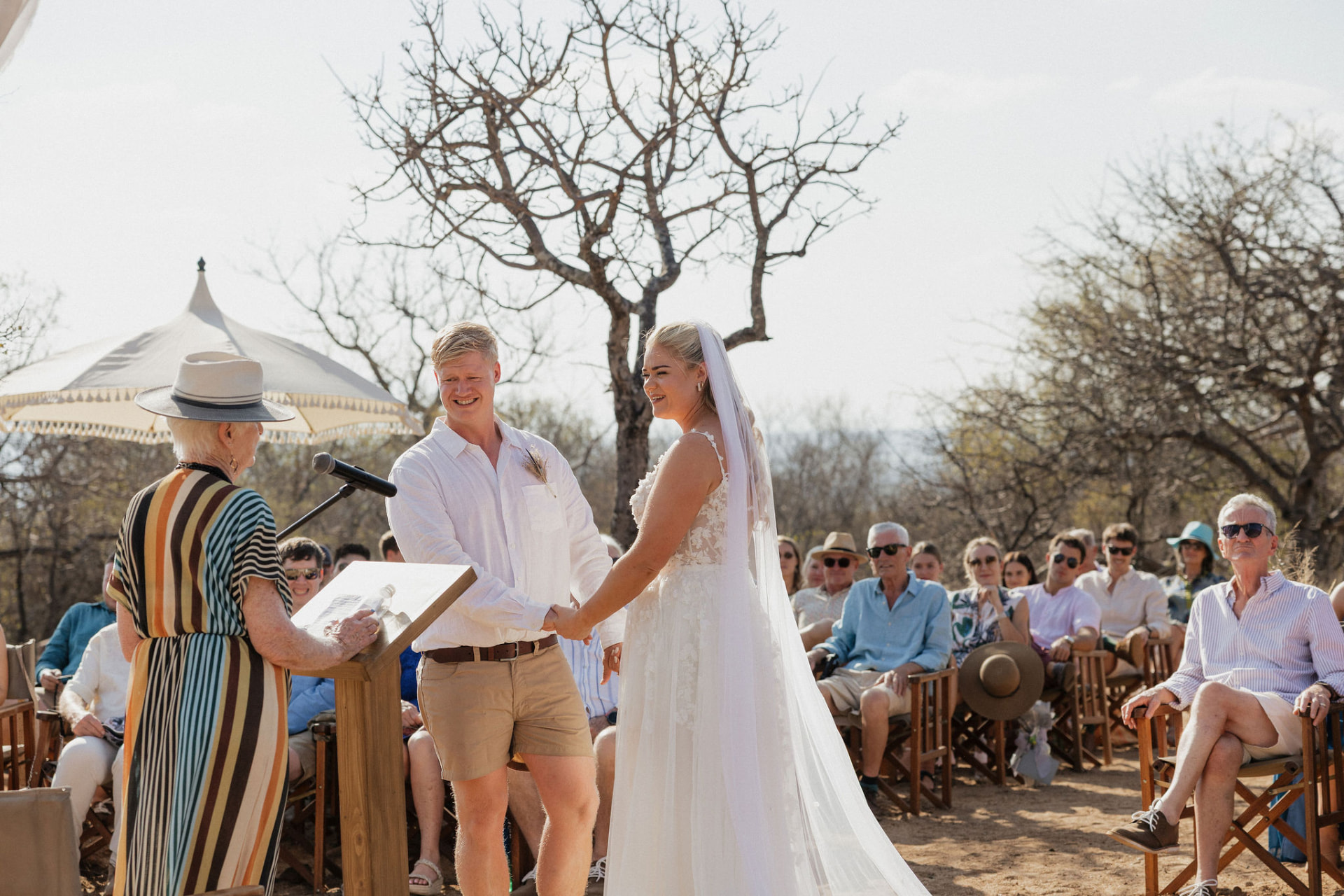 Bride and groom exchanging vows beneath a marula tree